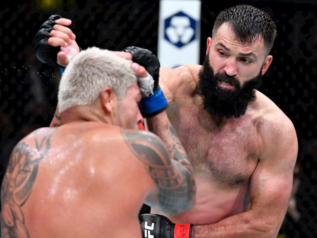 Andrei Arlovski delivers powerful punch to Jared Vanderaa in intense high definition MMA fight Wallpaper