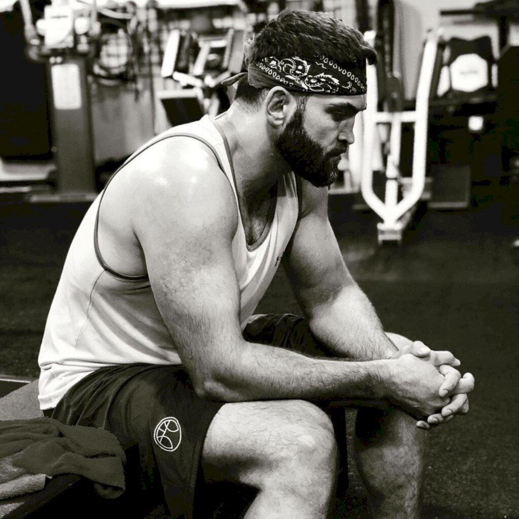 Andrei Arlovski resting and reflecting at Jackson Wink MMA gym black and white focus dedication Wallpaper