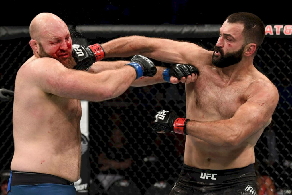 Andrei Arlovski and Ben Rothwell UFC fight intense face off raw power and determination inside octagon Wallpaper