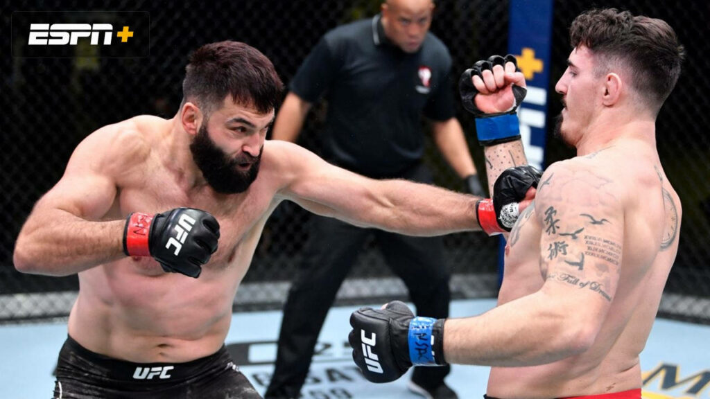 Andrei Arlovski throws powerful punch at Jared Vanderaa in intense UFC octagon fight action wallpaper