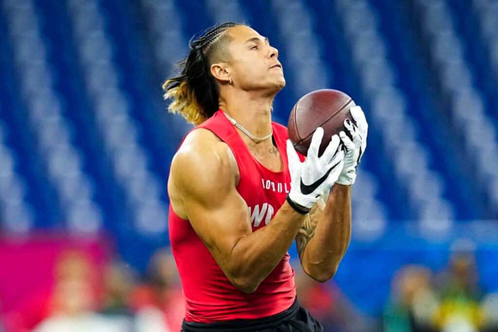 Andrei Iosivas catches football during intense drill showcasing athleticism and determination wallpaper