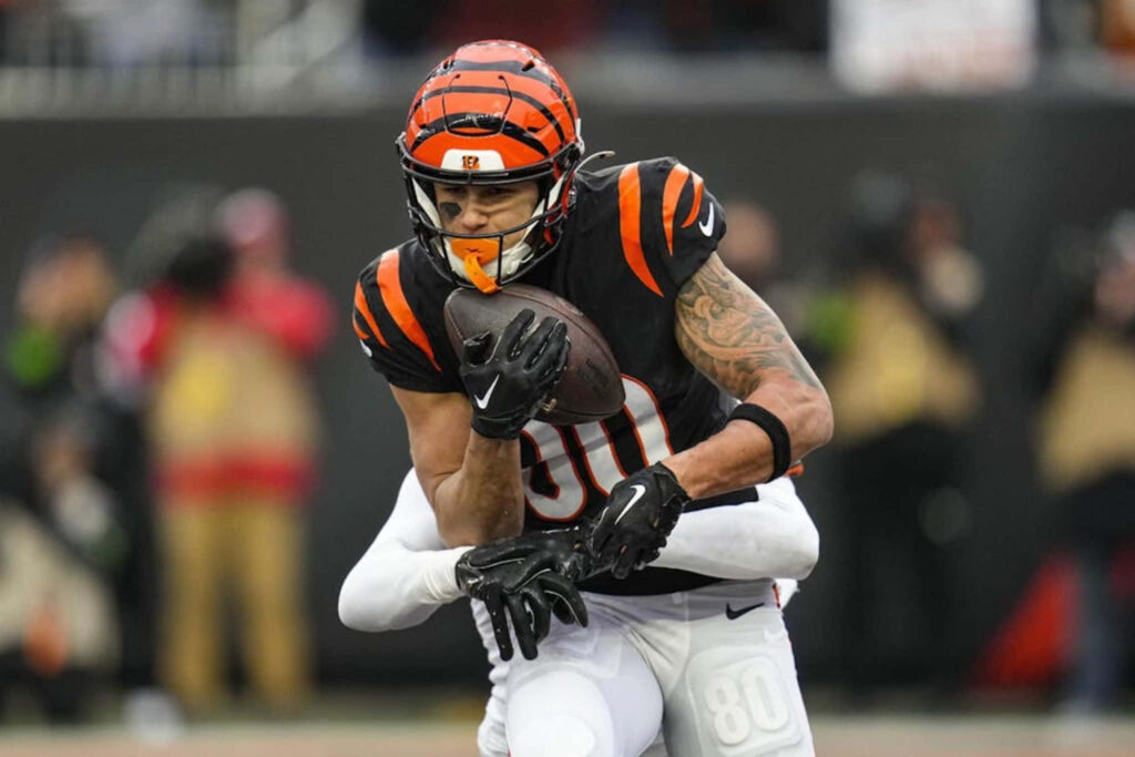 Andrei Iosivas makes a determined football catch midair in an intense game action scene Wallpaper