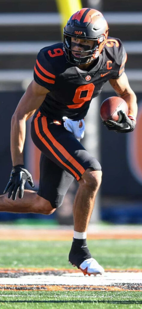 Andrei Iosivas sprinting with football focused determined dynamic athleticism wallpaper background