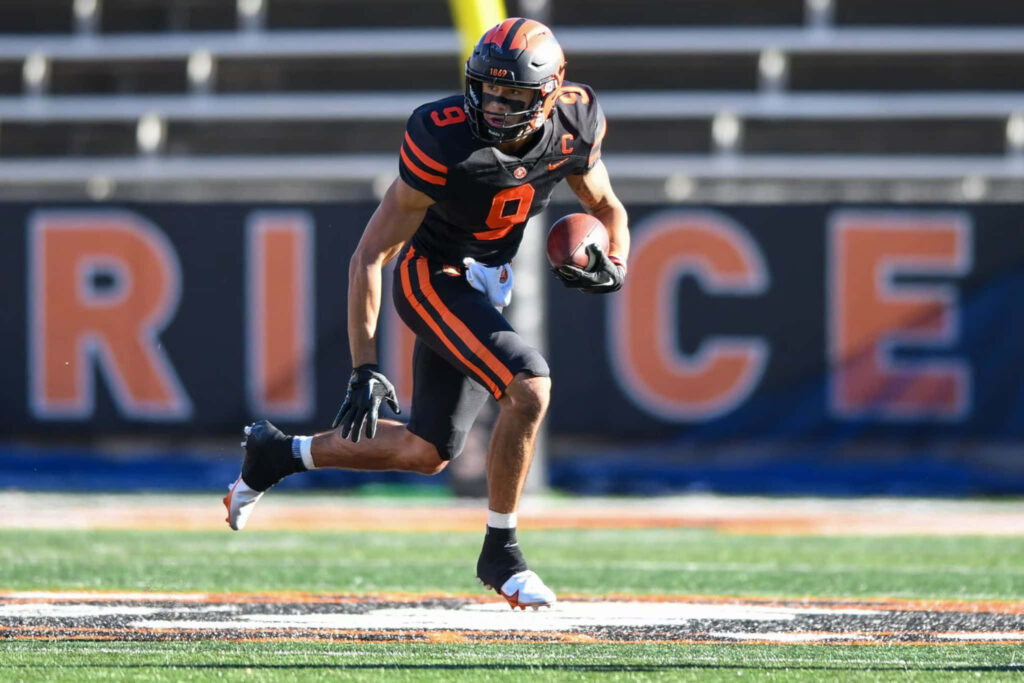 Andrei Iosivas sprinting with football on field showcasing athleticism and game focus wallpaper