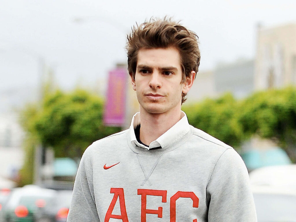 Andrew Garfield smiling outdoors wearing light gray AFC sweatshirt casual relaxed background Wallpaper