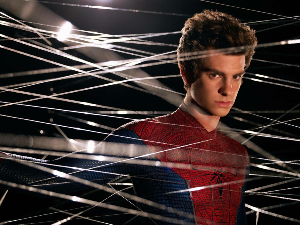 Andrew Garfield as Spider-Man behind a detailed web dynamic Marvel superhero wallpaper background