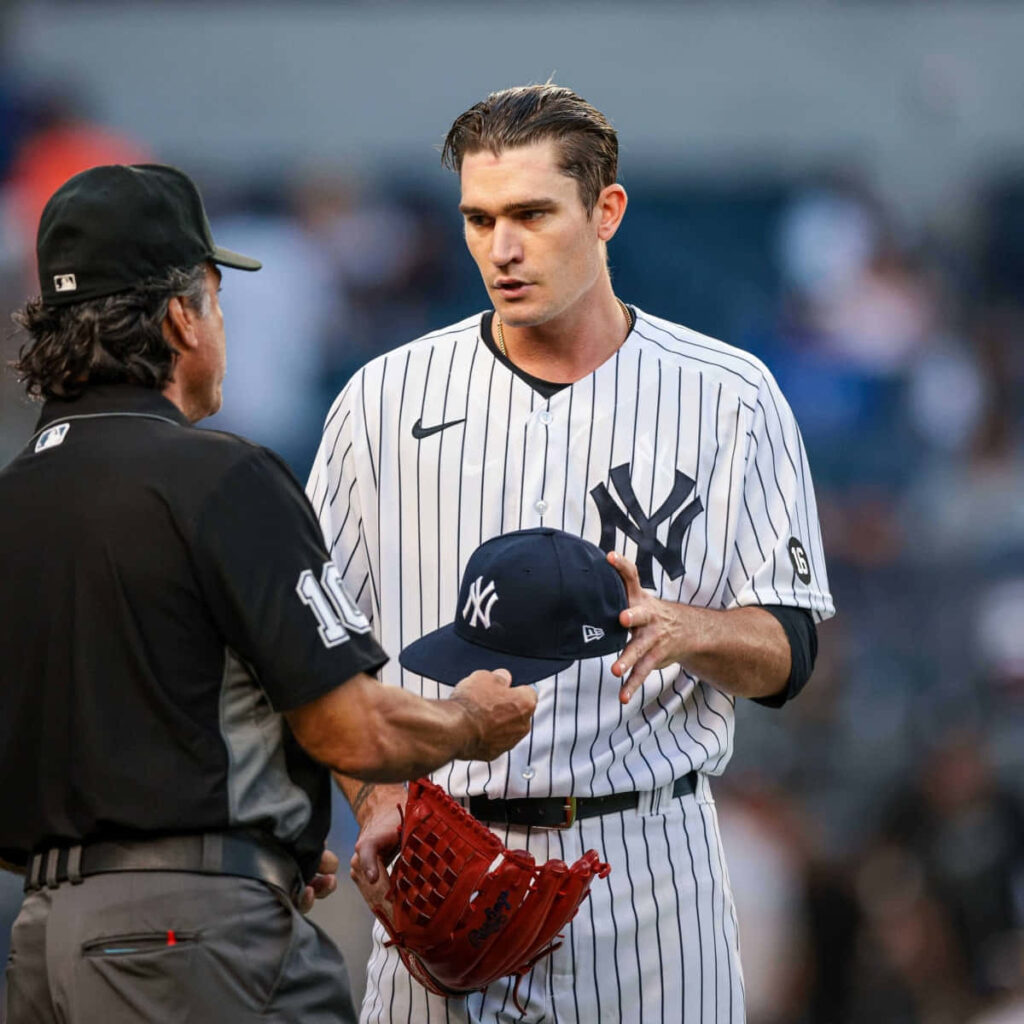 Yankees pitcher Andrew Heaney in intense on-field discussion with umpire during baseball game Wallpaper