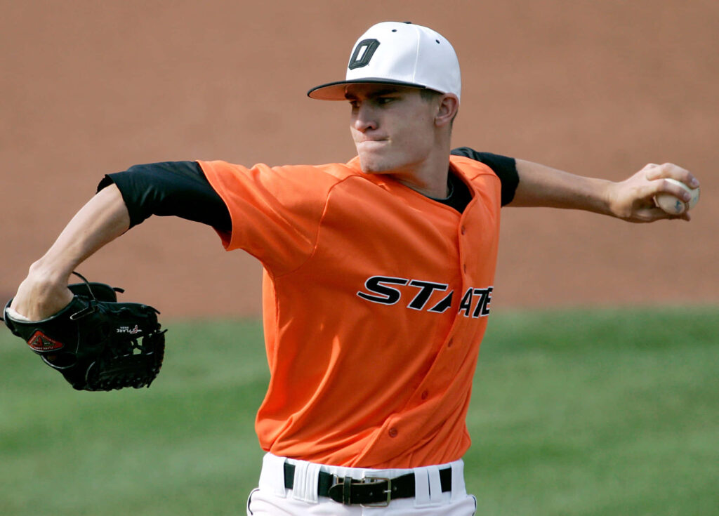Andrew Heaney pitching in orange jersey on baseball field showing focus and athletic skill Wallpaper