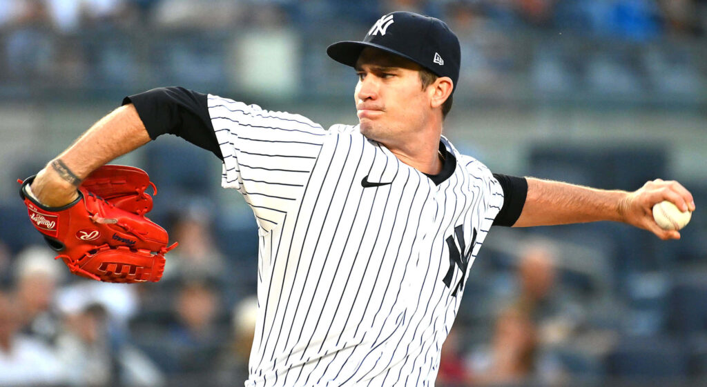 Yankees pitcher Andrew Heaney mid-pitch in classic pinstriped uniform on dynamic mound wallpaper