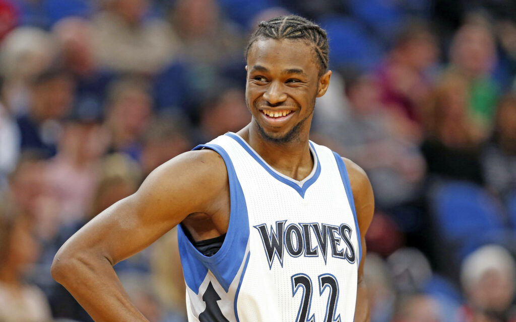 Andrew Wiggins smiling confidently in Minnesota Timberwolves jersey basketball court wallpaper