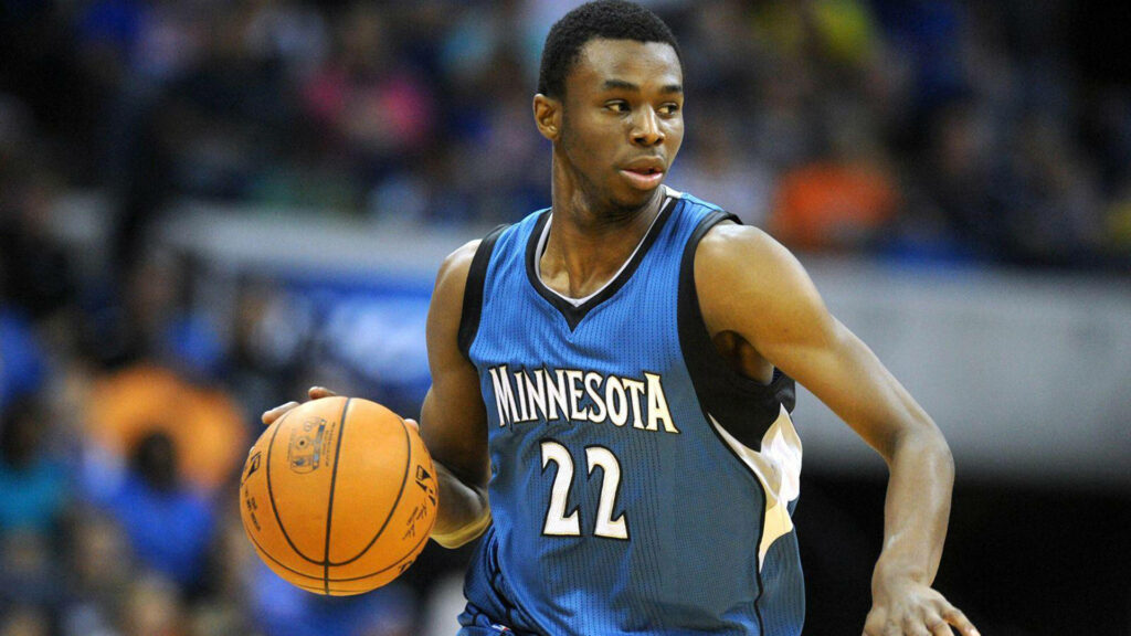 Andrew Wiggins dribbling basketball in Minnesota Timberwolves jersey dynamic sports wallpaper