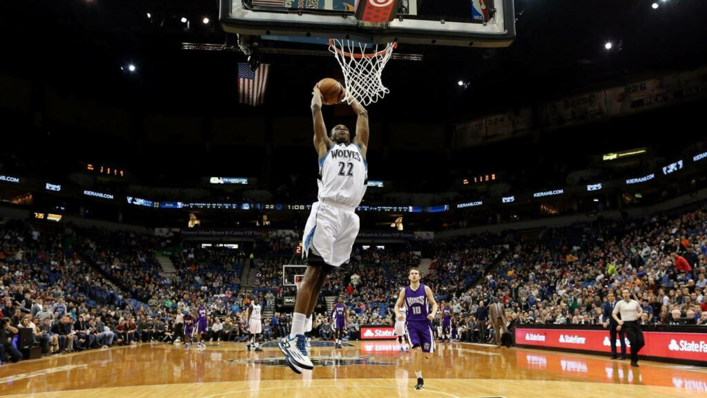 Andrew Wiggins powerful dunk at Target Center basketball game with packed crowd background Wallpaper