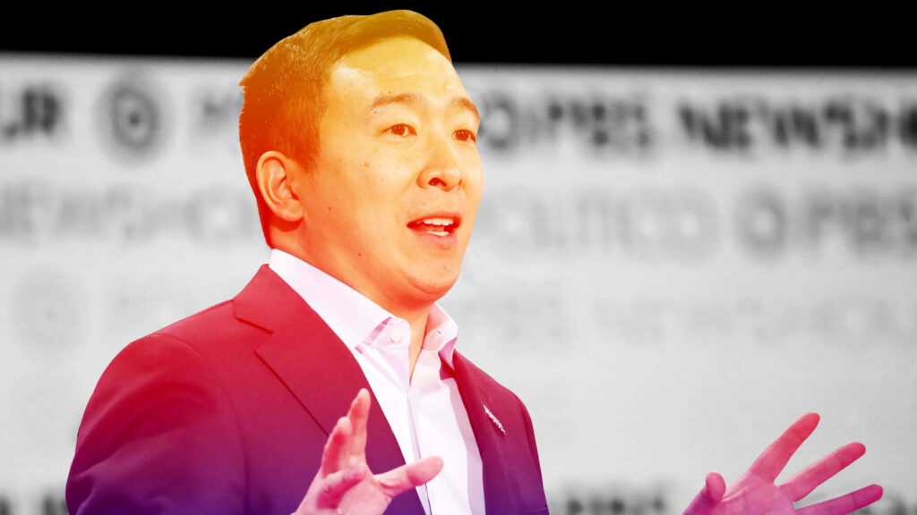 Andrew Yang wallpaper with orange tint formal attire animated expression blurred background