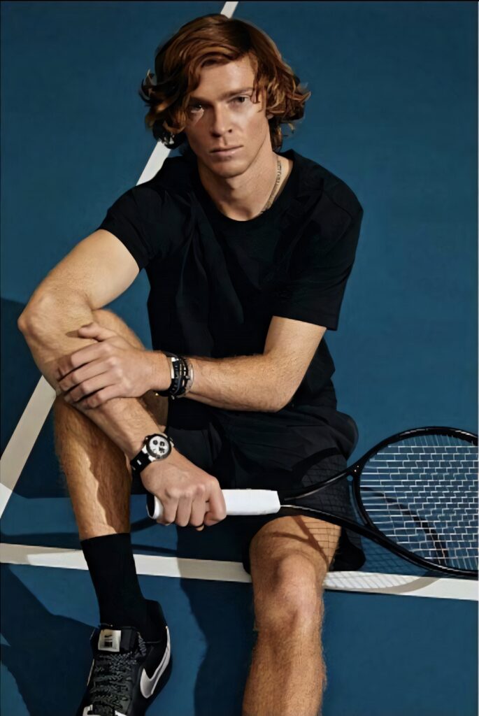 Andrey Rublev focused and determined sitting on tennis court rising tennis star wallpaper background