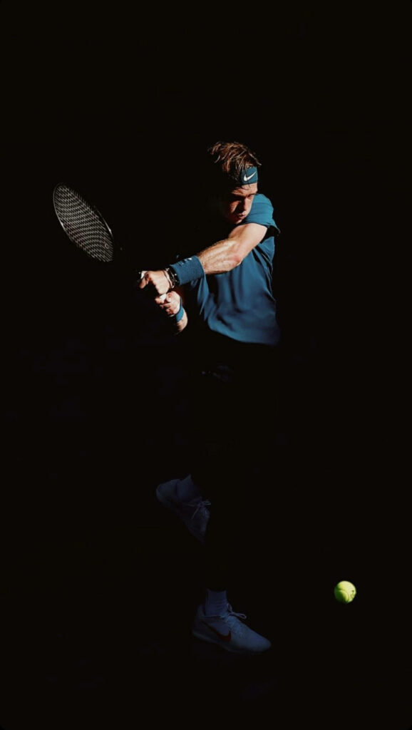 Andrey Rublev focused preparing to hit tennis ball dynamic motion dark dramatic background wallpaper