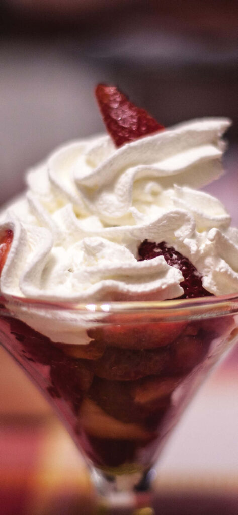 Chocolate Sundae in a Clear Glass Delightfully Stands Out amidst a Blurred Dessert Background Wallpaper