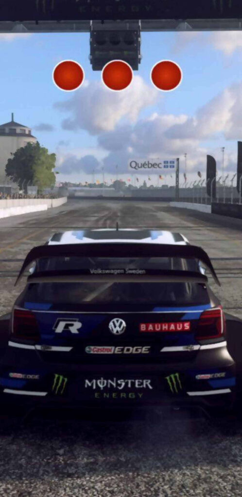 Dirt Rally Video Game Player's View: Volkswagen Rally Car at Starting Line with Red Lights, Sponsors, and Dusty Track Wallpaper