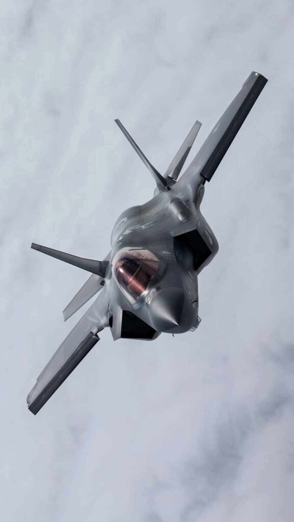 High-Tech Stealth: F-35A Slicing through the Clouds in a Minimalist Jumbo Jet Photo Wallpaper