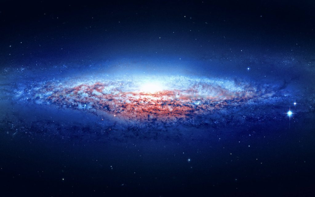 Radiant Andromeda Galaxy with glowing core and spiral arms against dark cosmic background stars Wallpaper