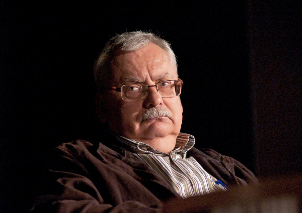 Andrzej Sapkowski serious thoughtful expression at event wallpaper background image