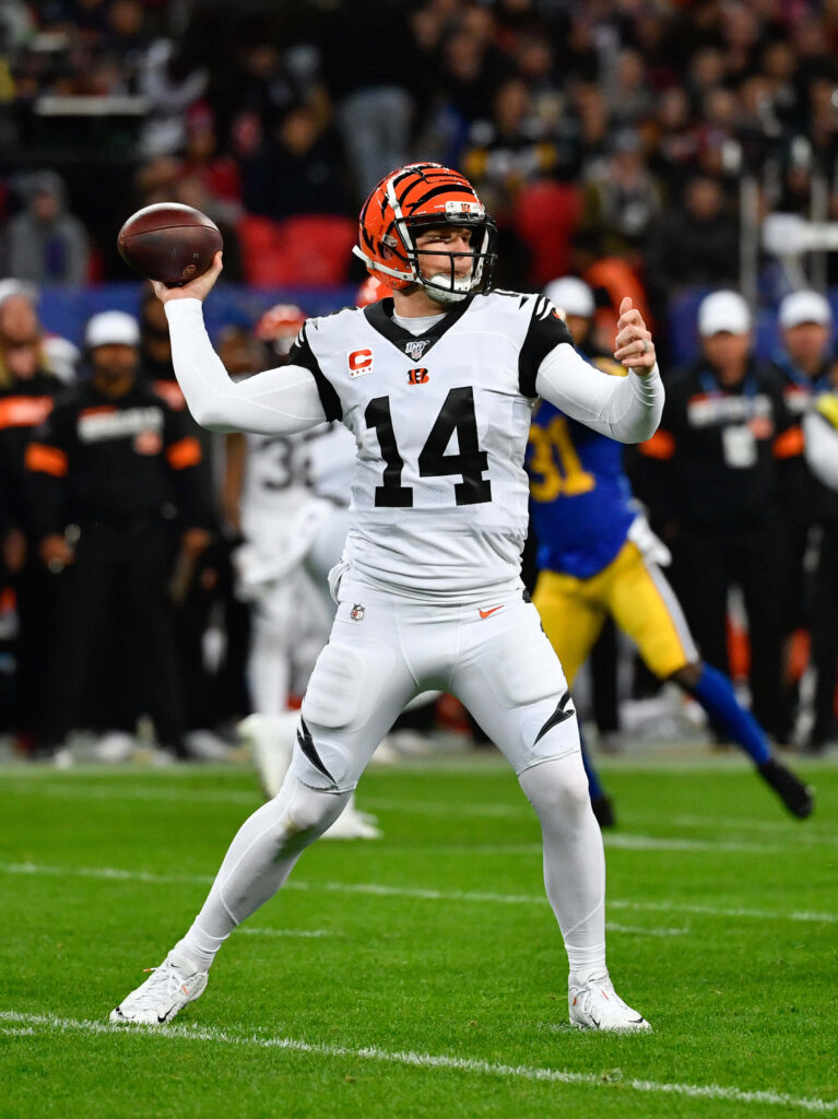 Andy Dalton mid-throw in Bengals uniform focused quarterback action football wallpaper background