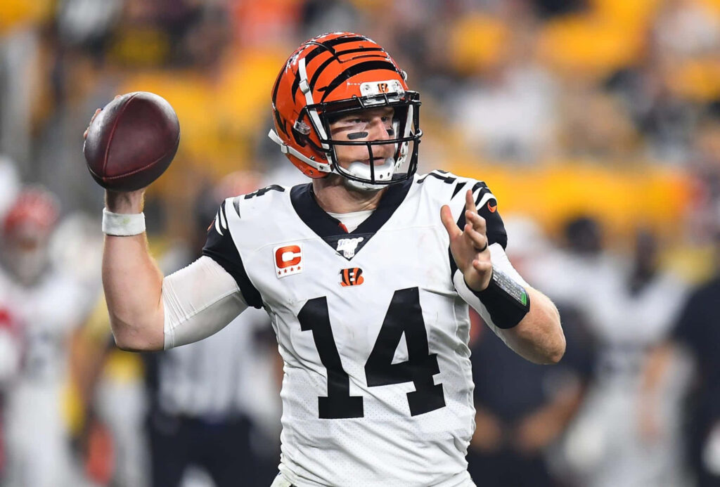 Andy Dalton Cincinnati Bengals quarterback mid-throw focused athleticism football wallpaper background