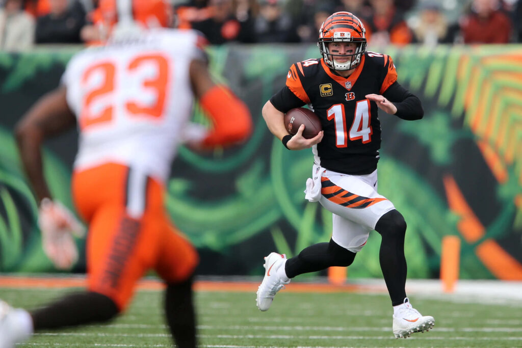 Andy Dalton Cincinnati Bengals quarterback running with football during intense game action wallpaper