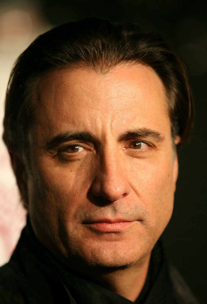 Close-up portrait of Andy Garcia with confident expression on stylish wallpaper background
