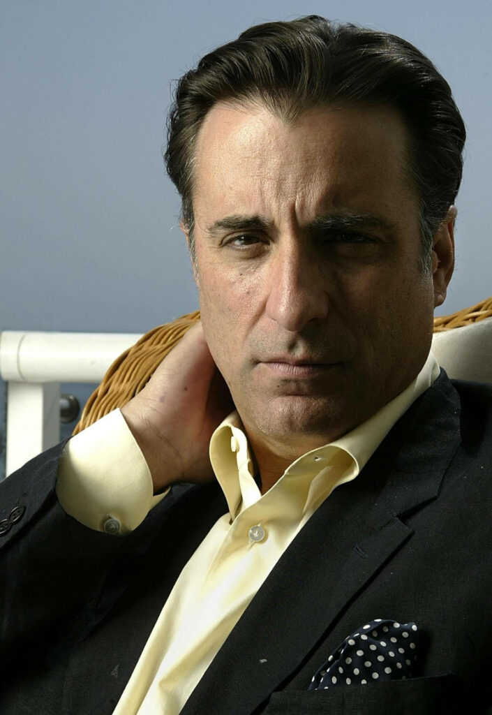 Andy Garcia sitting outdoors in chair calm intense presence sophisticated wallpaper background