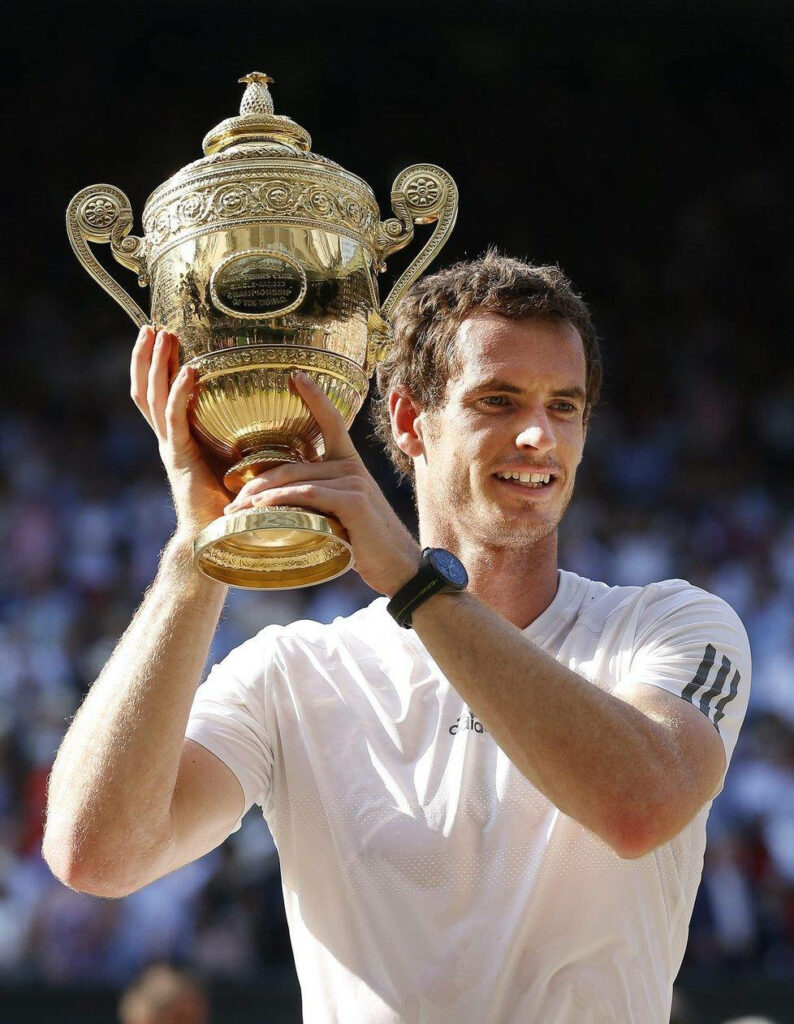 Andy Murray celebrates historic Wimbledon victory holding trophy high on tennis court wallpaper background