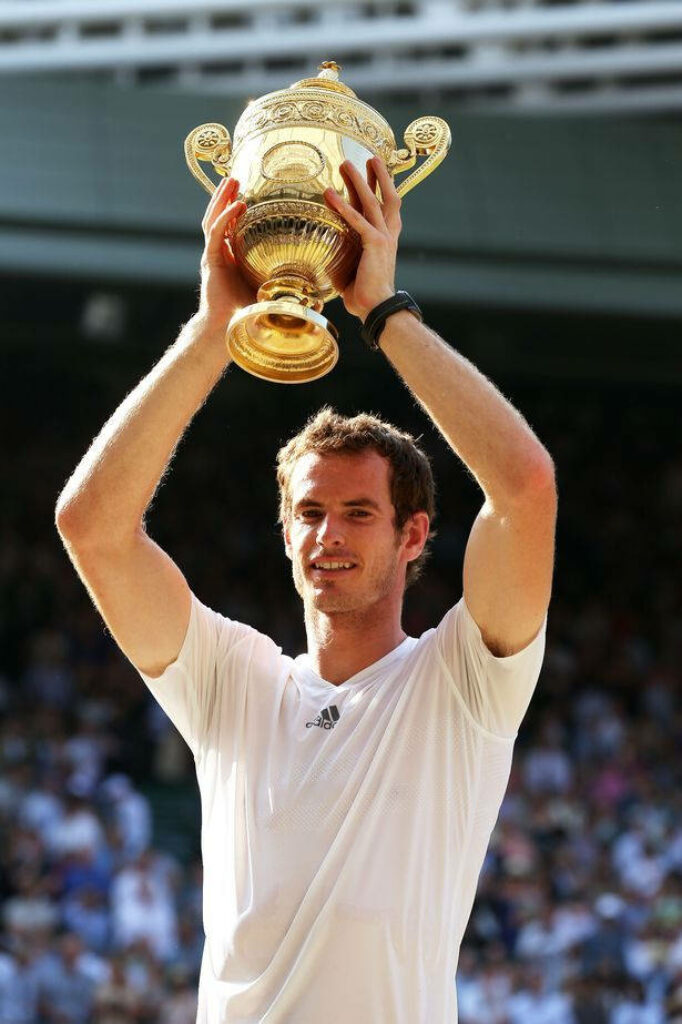 Andy Murray lifts Wimbledon trophy celebrating historic tennis victory on court wallpaper background