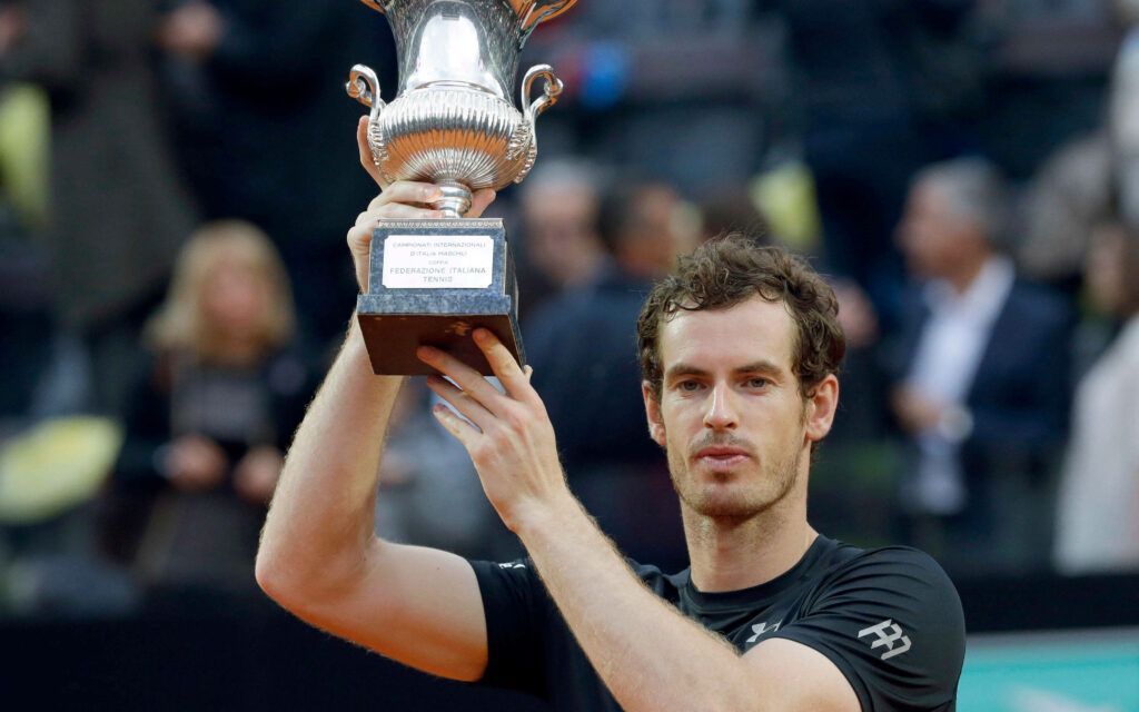 Andy Murray lifts Italian Open trophy in victory on tennis court with triumphant wallpaper backdrop