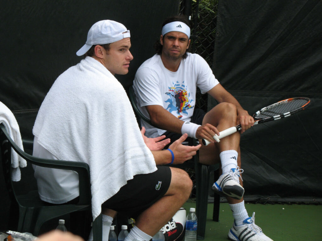 Andy Roddick sitting courtside with towel during tennis practice break conversation wallpaper