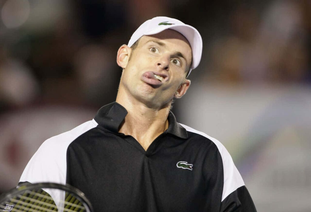 Andy Roddick playful funny face on tennis court during match vibrant wallpaper background