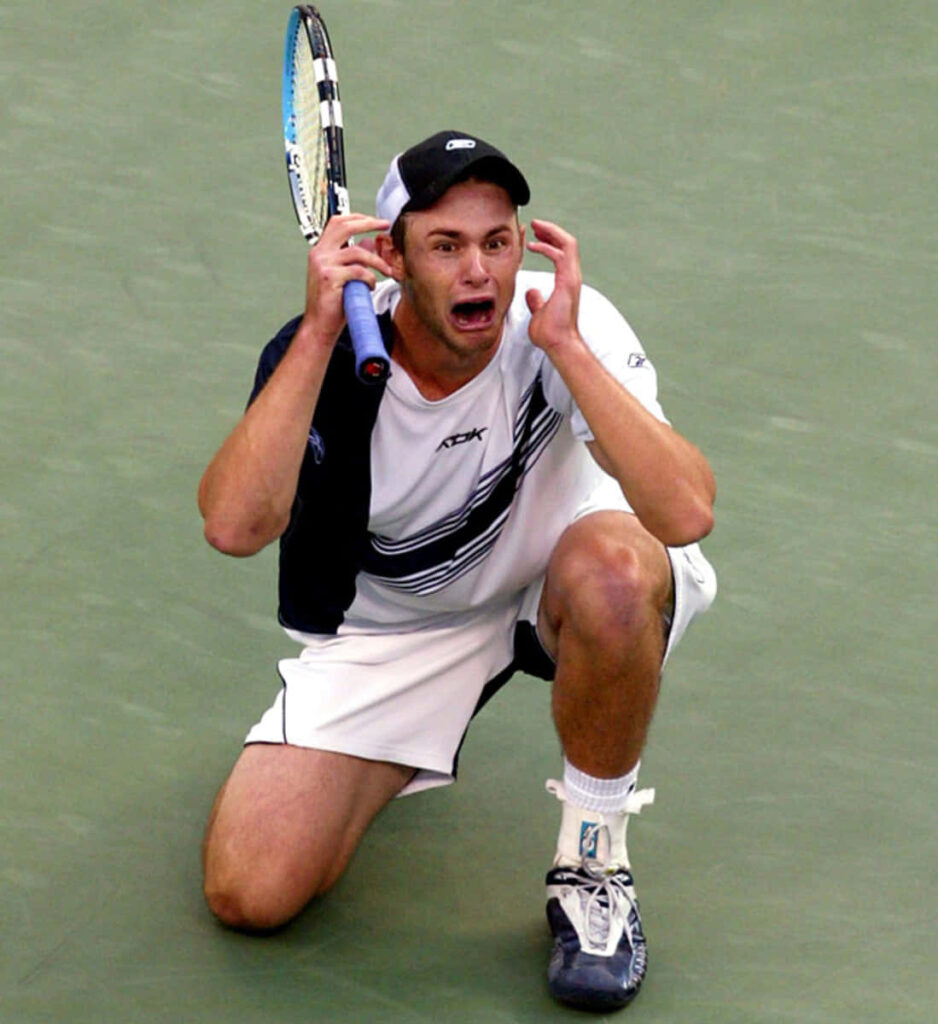 Andy Roddick shocked expression intense moment tennis court dynamic sports wallpaper background