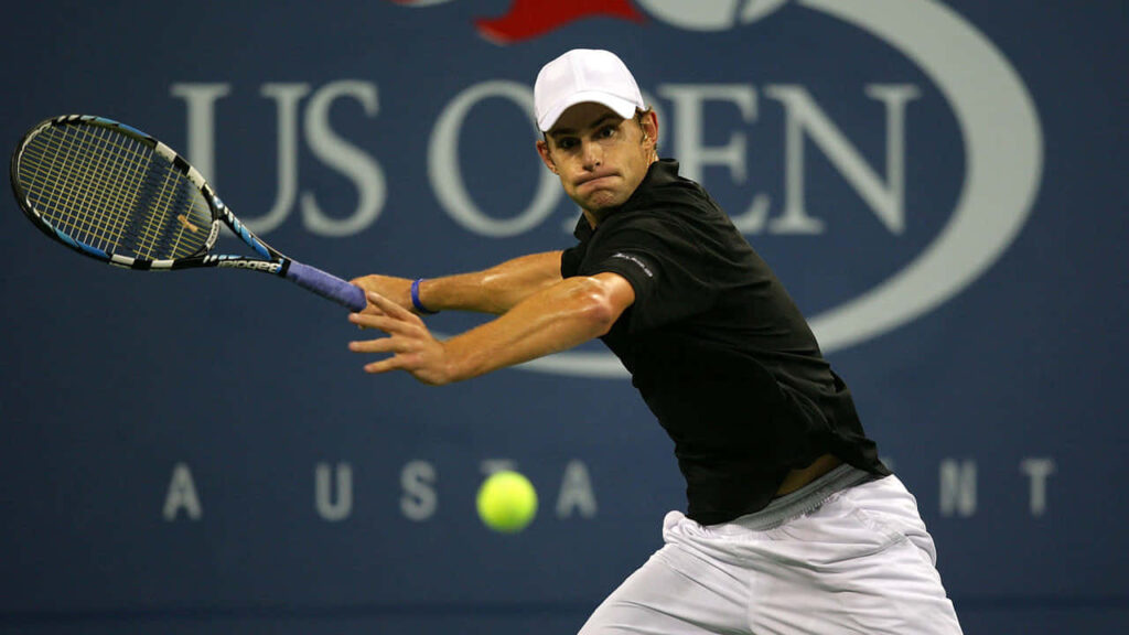 Andy Roddick focused preparing to return shot during intense US Open tennis match wallpaper background