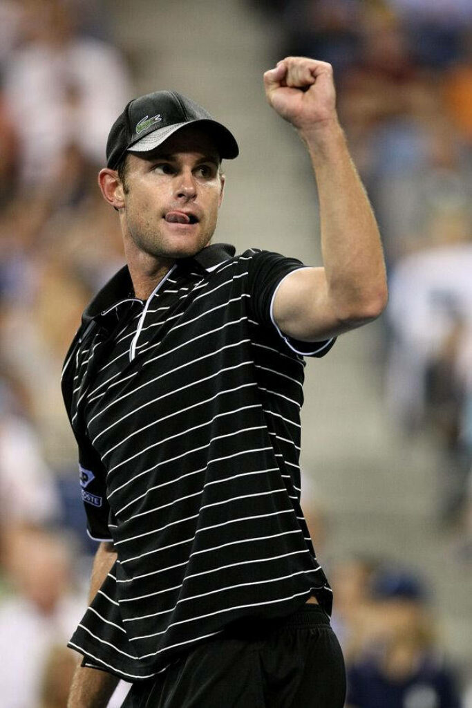 Andy Roddick celebrates tennis victory with raised arm showing passion and determination wallpaper