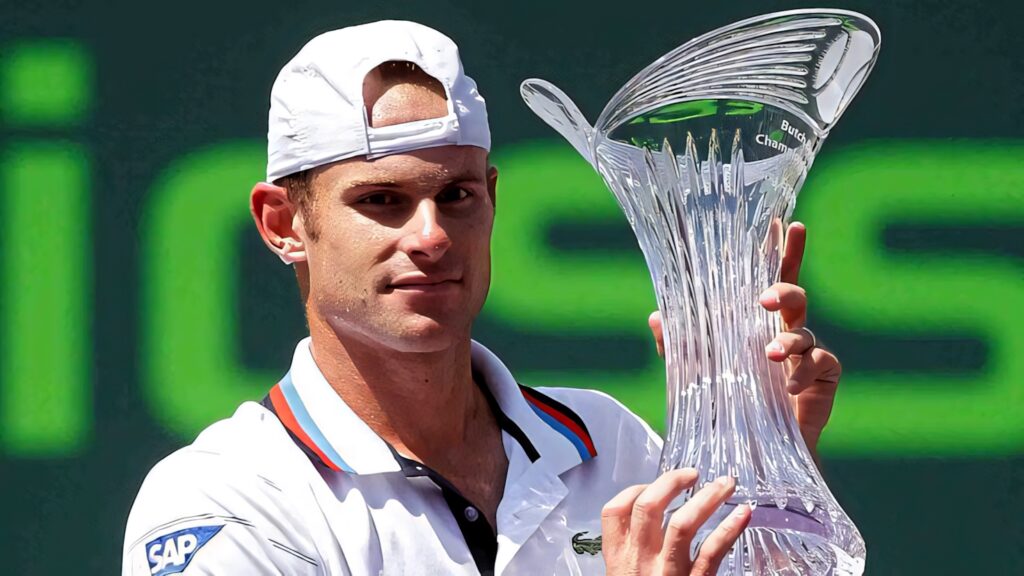 Andy Roddick celebrating major tennis tournament victory holding trophy on court wallpaper background