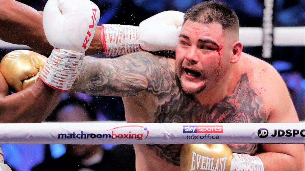 Andy Ruiz Jr mid-fight with eye injury and blood in intense professional boxing match wallpaper background