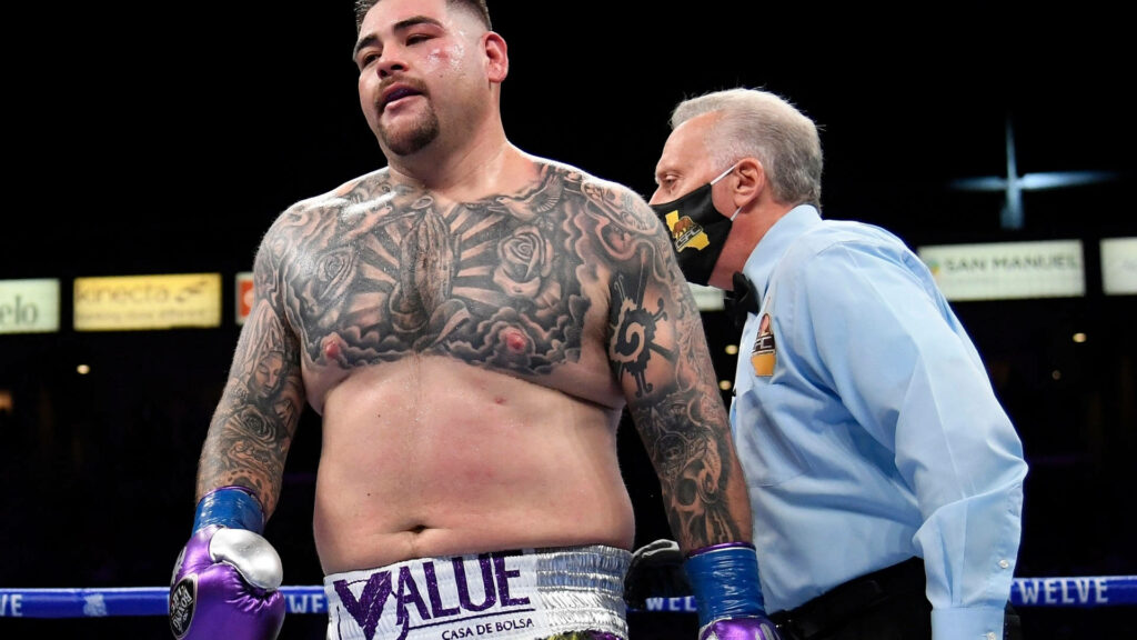 Andy Ruiz Jr in boxing ring with referee showing tattooed physique after match wallpaper background