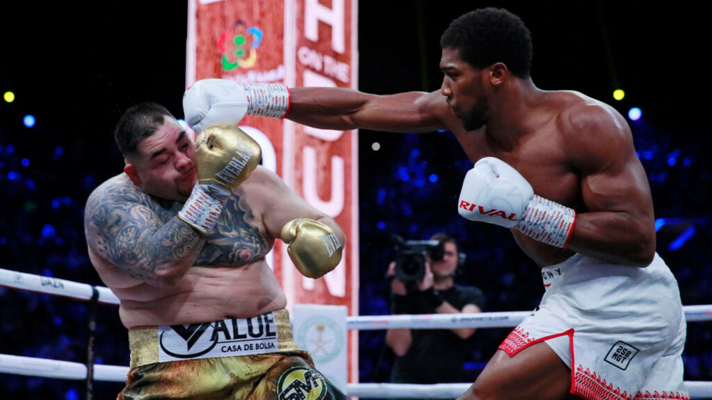 Andy Ruiz Jr dodges a powerful punch in intense boxing match showcasing defense skills wallpaper