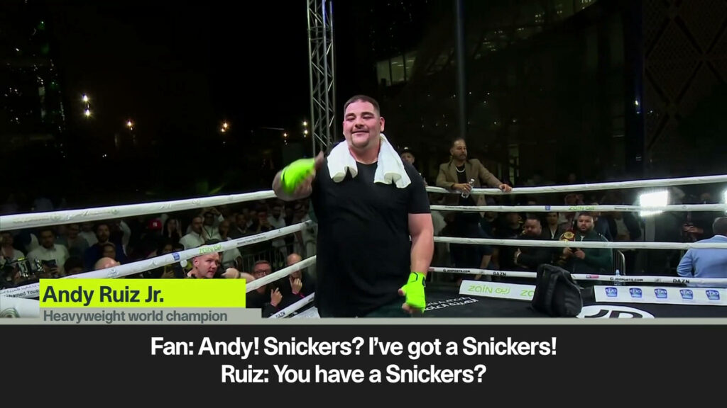 Andy Ruiz Jr smiling and engaging with fan inside boxing ring during lively crowd interaction wallpaper
