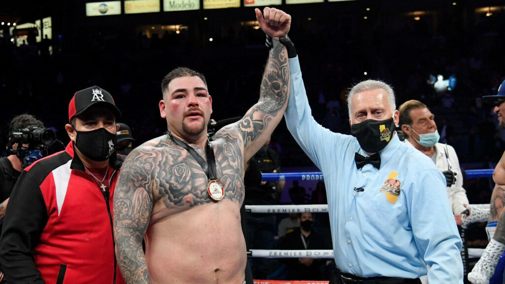 Andy Ruiz Jr victorious in boxing ring with raised hand surrounded by supporters and officials Wallpaper