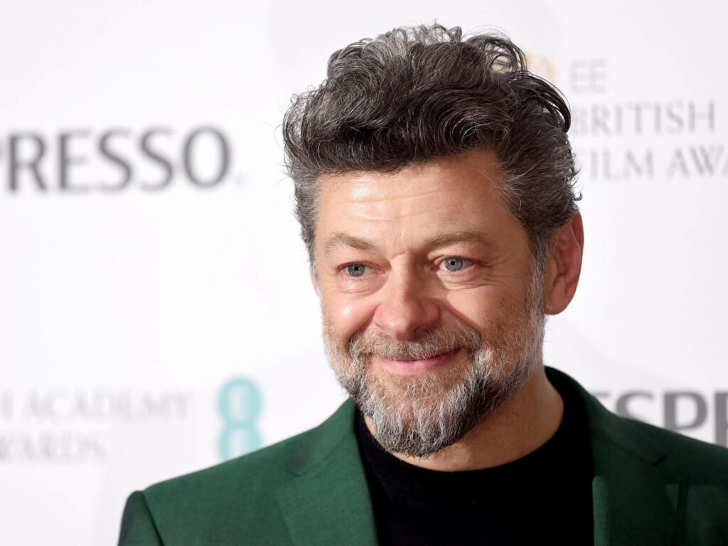 Andy Serkis smiling warmly high-resolution wallpaper charismatic portrait with soft professional background