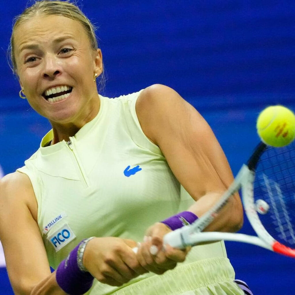 Anett Kontaveit returning tennis shot with intense focus demonstrating athleticism and determination Wallpaper