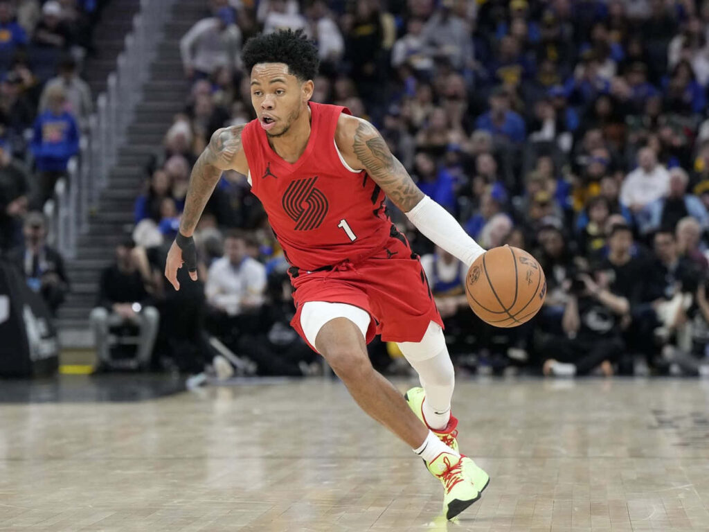 Anfernee Simons dribbling basketball on court demonstrating agility in intense game action wallpaper