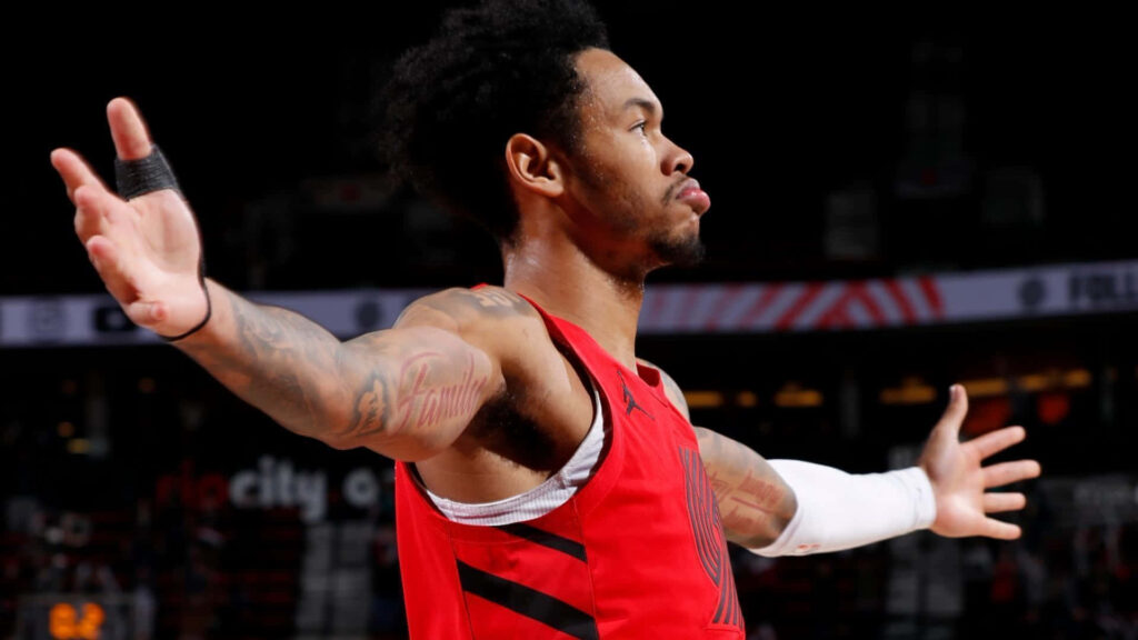 Anfernee Simons confident basketball stance arms outstretched strong focus court presence wallpaper