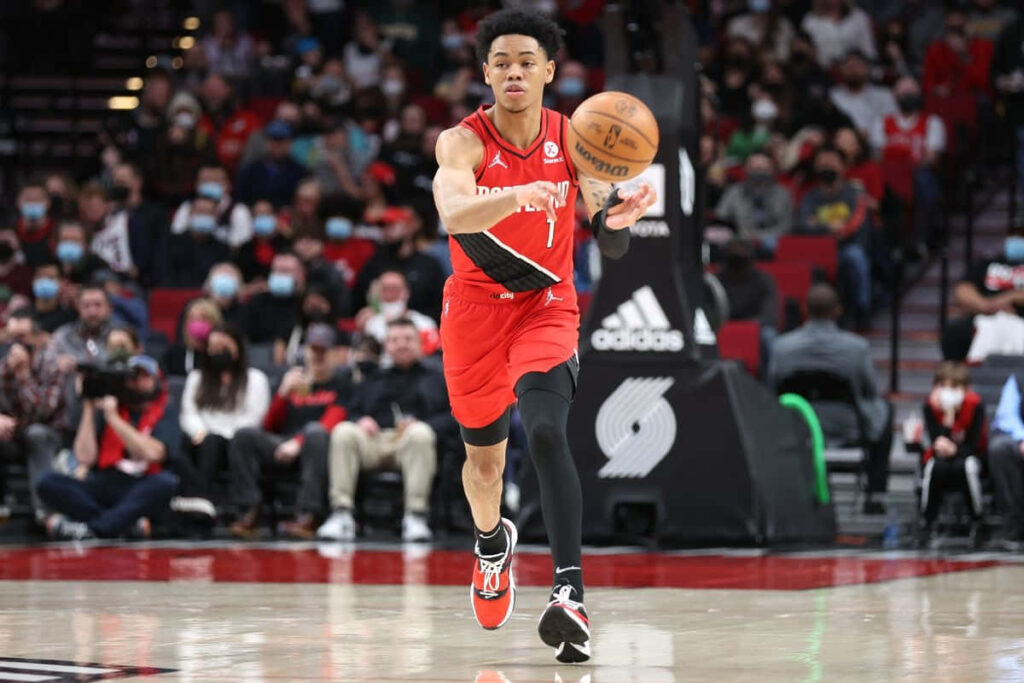 Anfernee Simons focused dribbling basketball intense NBA game athletic action wallpaper background