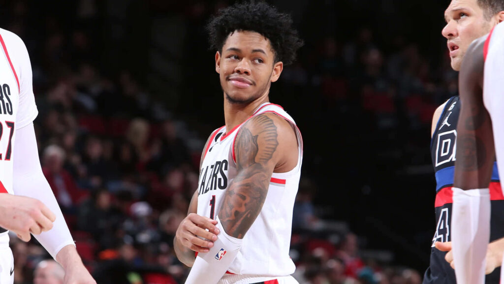 Anfernee Simons in Portland Trail Blazers uniform focused courtside intense basketball game wallpaper