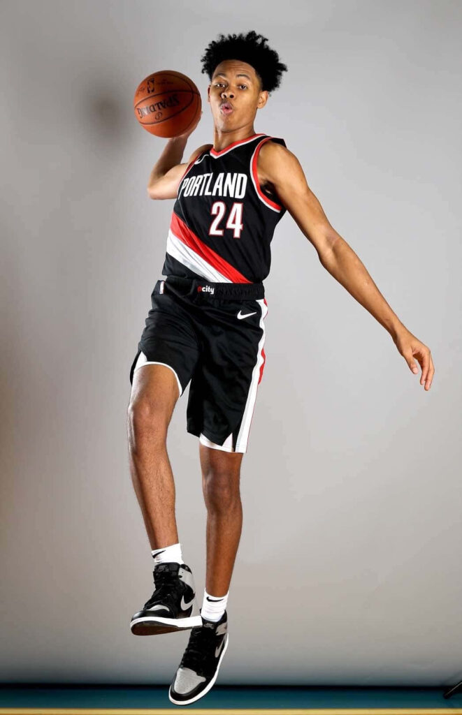 Anfernee Simons mid-air basketball dunk Portland Trail Blazers dynamic athletic wallpaper background